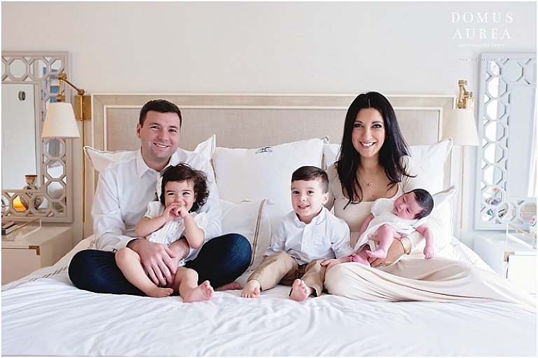 Family portrait on bed at newborn session.