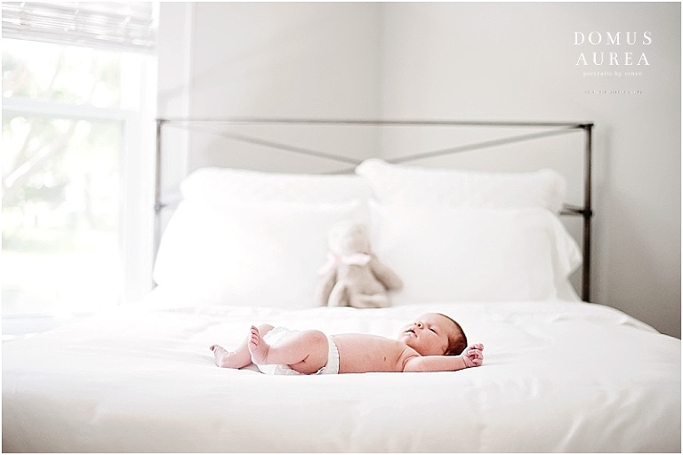 Newborn girl on white bed