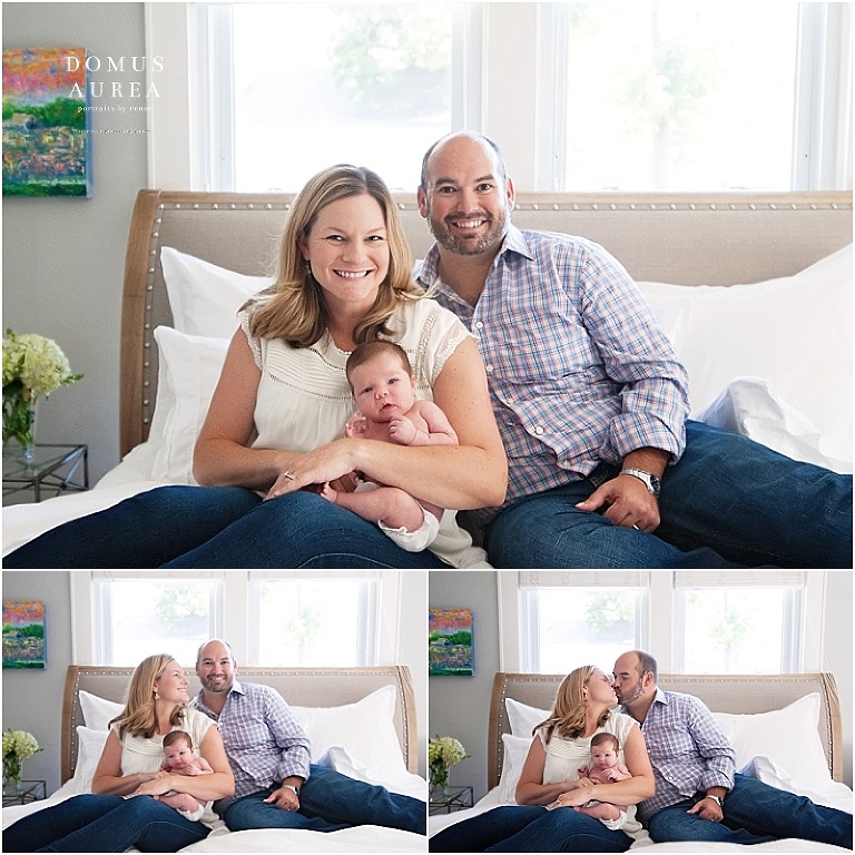 Parents sit on bed with their newborn baby