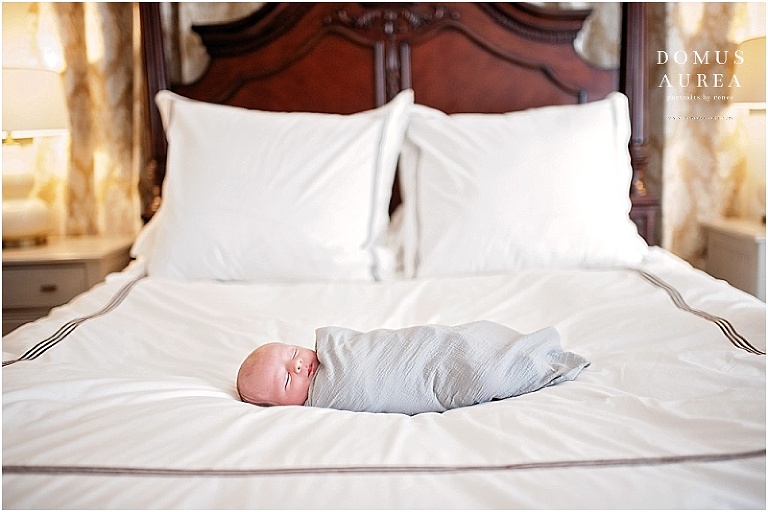 Precious baby boy sleeping on parent's bed