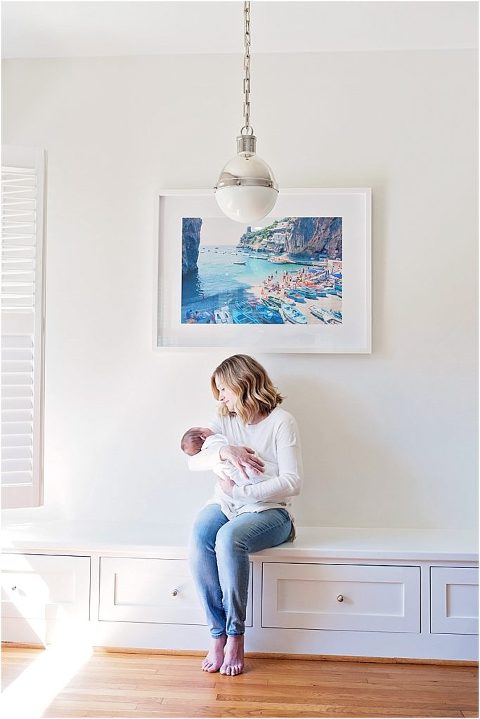 Mom sits down and looks at her newborn daughter