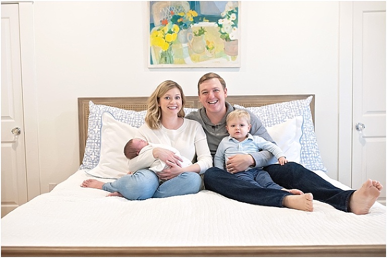 Newborn session photo on family bed.