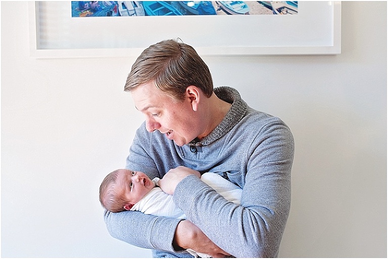 Precious moment during newborn session where baby and daddy make the same face