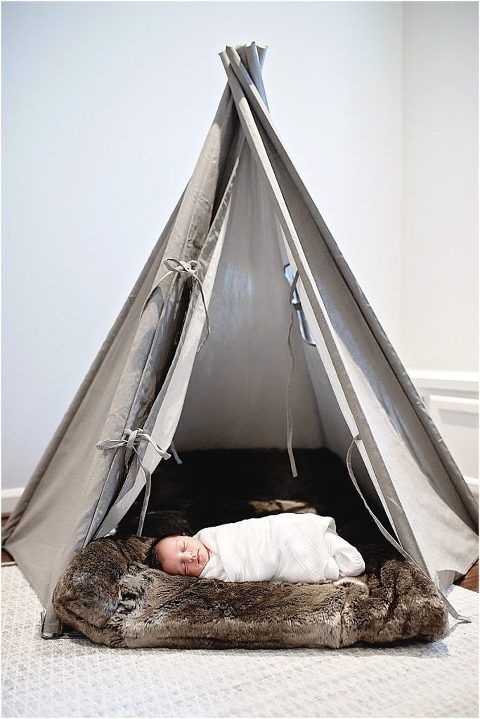 Baby sleeps swaddled in his tent.