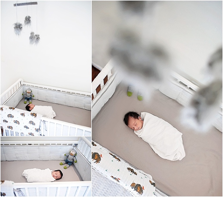 Baby lays in crib with mobile above him.