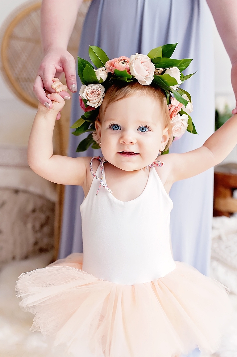 Baby girl smiles at camera