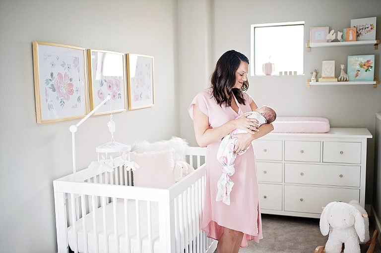 mommy holds baby in nursery