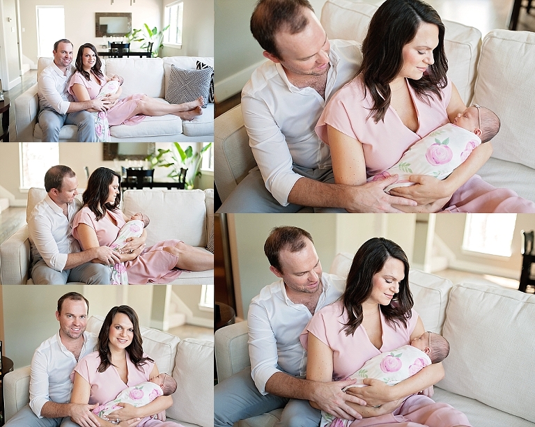 mommy and daddy hold baby daughter