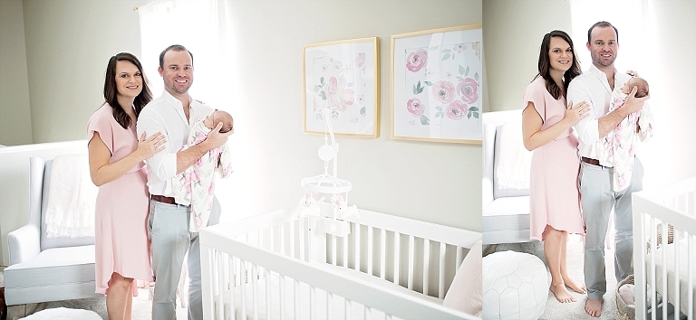 mommy and daddy pose for picture with newborn daughter in the nursery