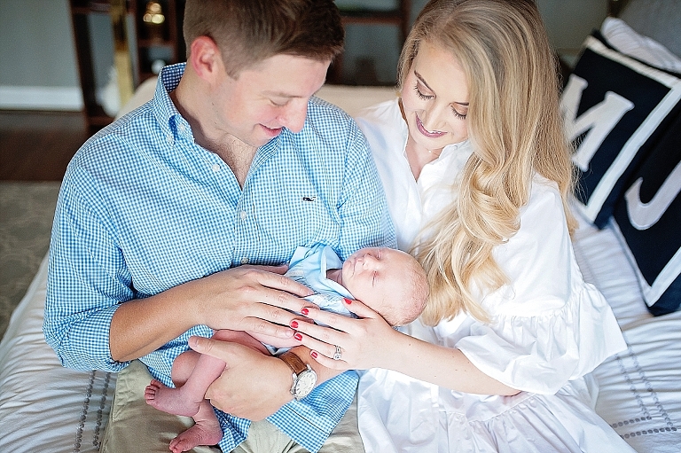 mommy and daddy hold and love their baby boy