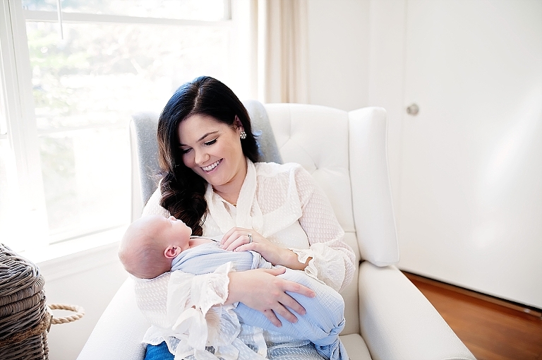 a mommy lovingly smiles at her baby boy