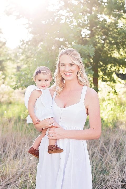 Mom and her daughter smile at the camera