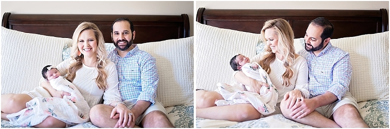 mom and dad snuggle their newborn baby