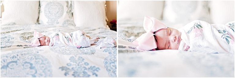 newborn babygirl lays on her parent's bed with big pink bow