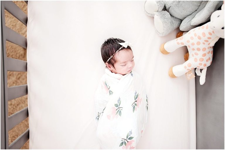 sweet sleeping newborn in her crib