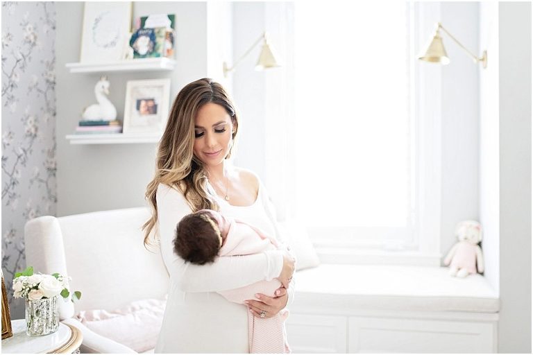 Mom looks at her daughter during newborn sessoin