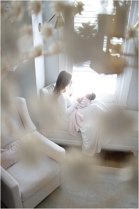 Beautiful image of mama and newborn through the chandelier