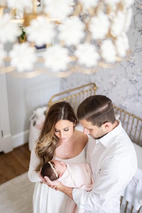 beautiful shot of mom and dad in nursery