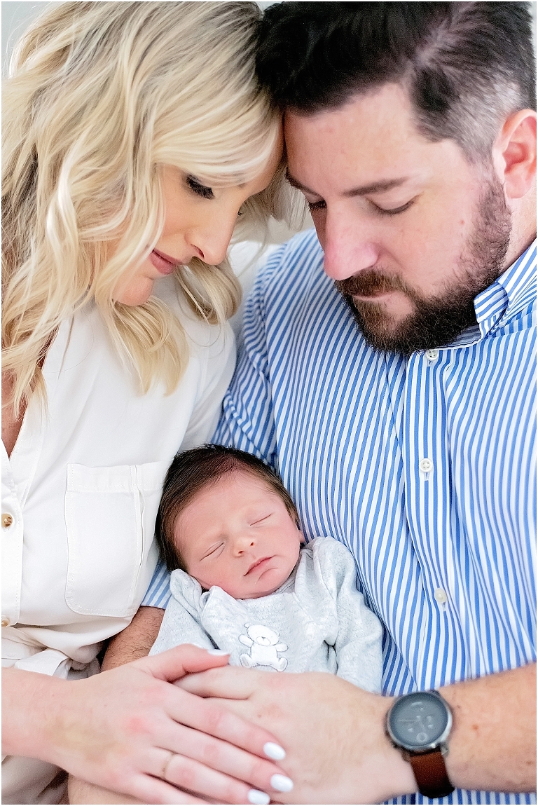 baby is held lovingly by parents