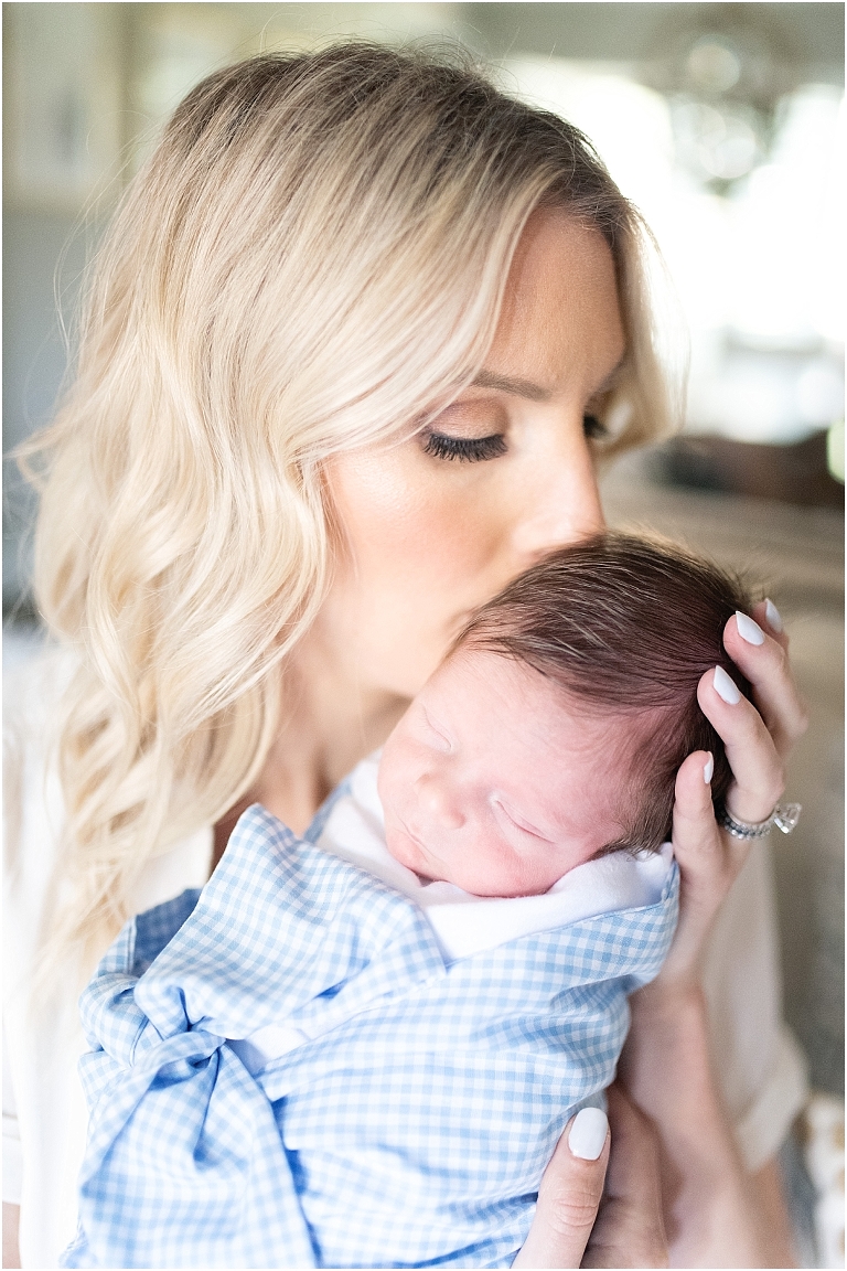 a new mom holds her newborn son during their newborn session