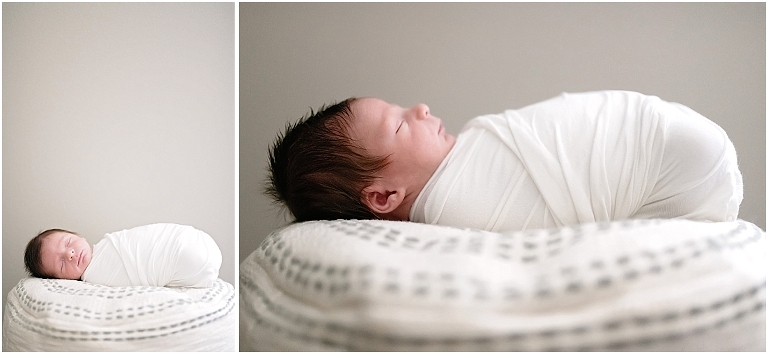 baby is swaddled and posed on a beanbag