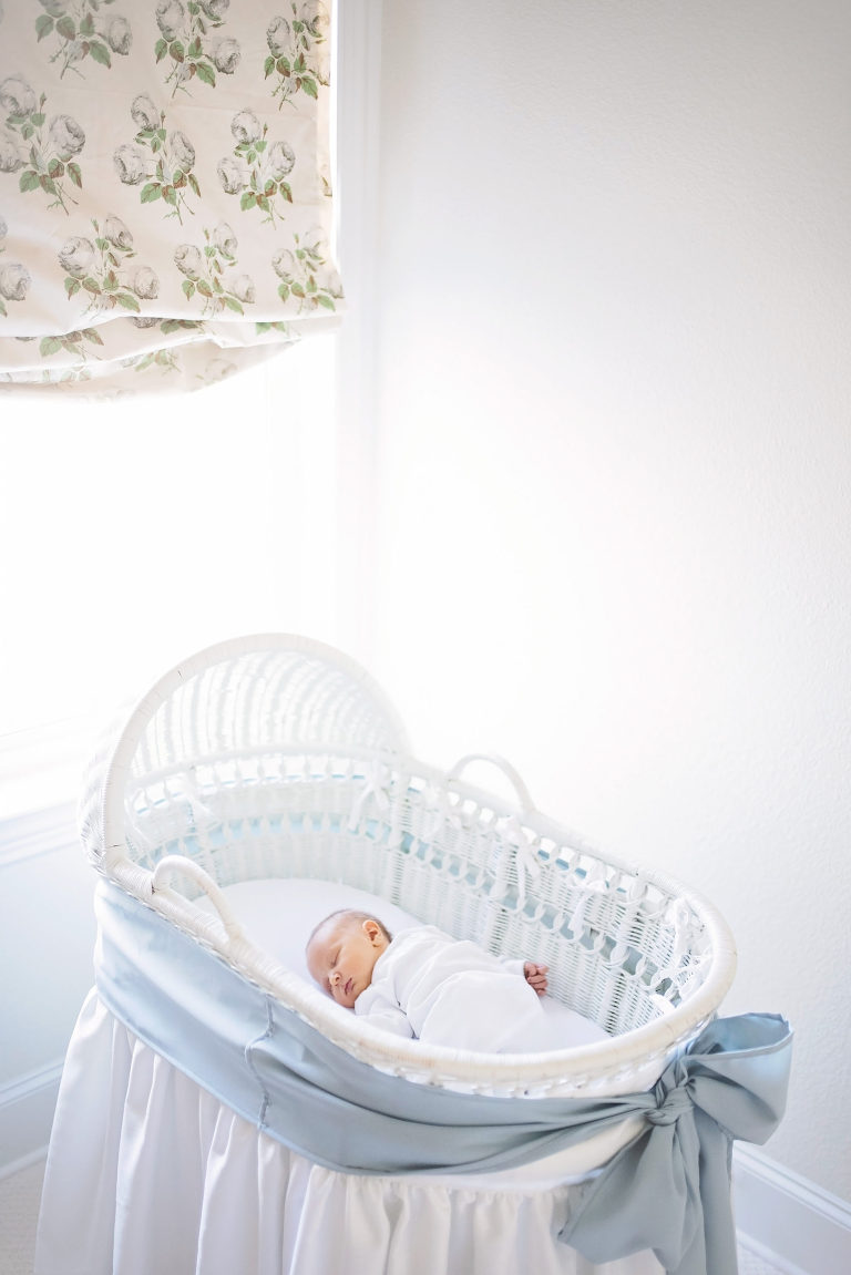 baby lays in bassinet