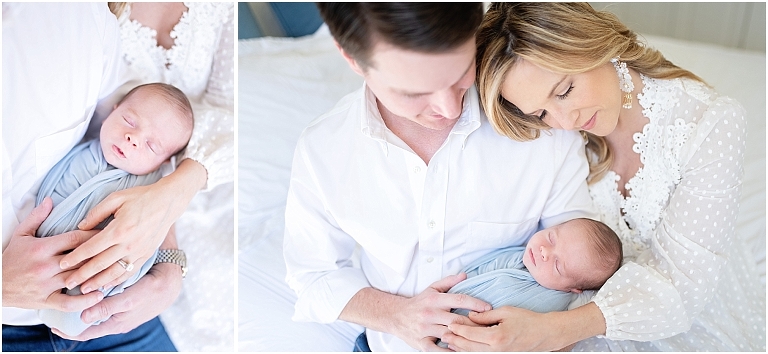 mom and dad sit together holding newborn