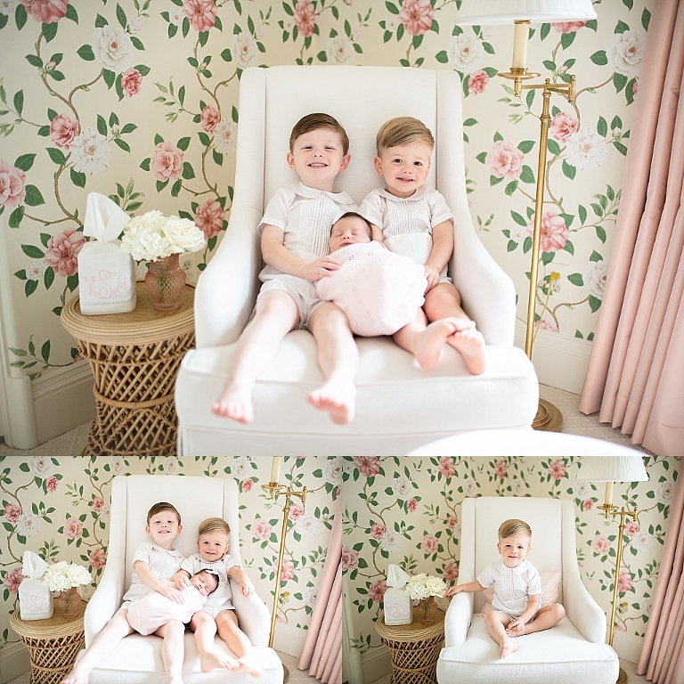 big brothers hold their little sister in a chair