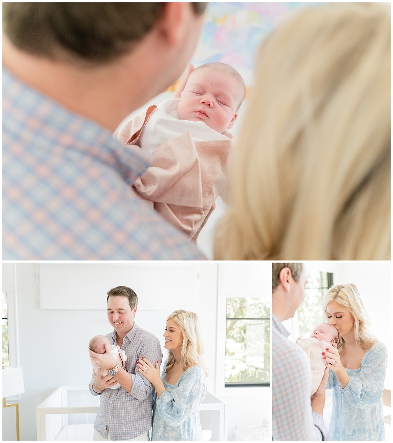 mom and dad hold their newborn girl